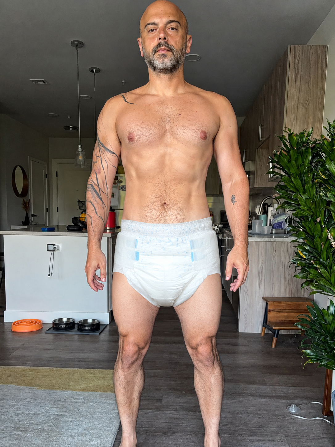 Eric Leffler standing in a kitchen wearing a diaper.